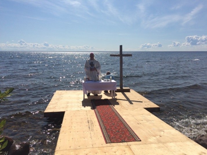 A special Mass was offered on Sunday July 26, which marked the conclusion of the Dene National Assembly hosted in Deline, and also the beginning of the first ever ‘Water Conference.’  During the Mass, the Great Bear Lake was dedicated to God, the Creator of All, who gives us His gift of water to sustain all life.  At the end of the Mass, several elders joined with Bishop Mark in blessing themselves and thanking God for His gift of the Water of the Great Lake.