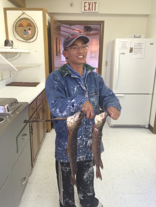 Peter showcases his great catch of fish from a nearby lake.
